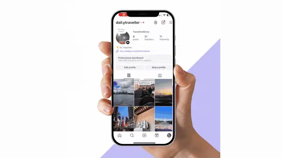 A hand holding a phone showing a creator's Collab Profile on Instagram, with their bio link, follower count, and grid of recent posts